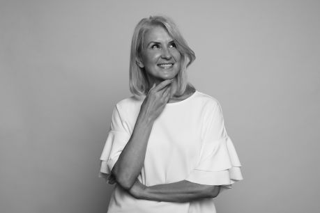 portrait of a beautiful 50 years woman is smiling, looking up